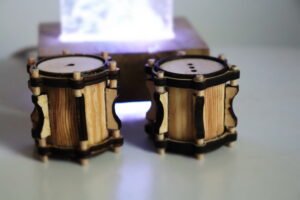 a pair of barewood with crome salt and pepper shakers shaped like drums